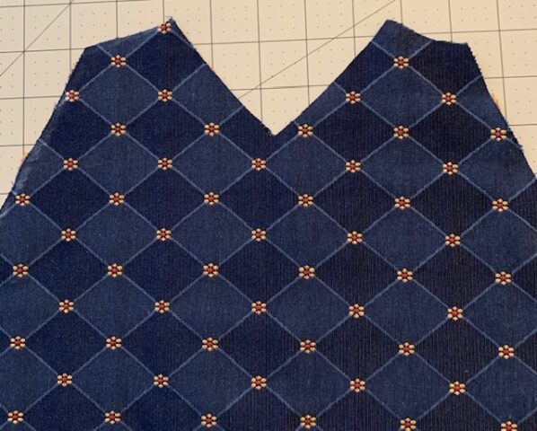 The left side panel spread out to show the lower edge of the deep armhole.